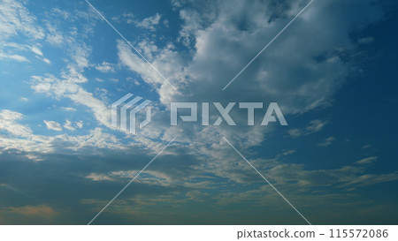 Sun rays and clouds in blue sky. atural sky backdrop weather conditions. Beautiful blue sky with sunbeams and clouds. Timelapse. 115572086