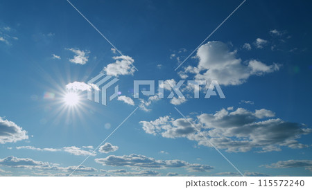 Natural light rays shining through the glittering clouds. Sky with fluffy clouds. Sun shining sunbeams. Timelapse. Natural light rays shining through the glittering clouds. Sky with fluffy clouds. Sun shining sunbeams. Timelapse. 115572240
