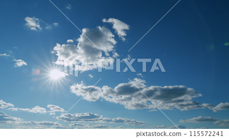 Sun rays and clouds in blue sky. atural sky backdrop weather conditions. Beautiful blue sky with sunbeams and clouds. Timelapse. Sun rays and clouds in blue sky. atural sky backdrop weather conditions. Beautiful blue sky with sunbeams and clouds. Timelapse. 115572241