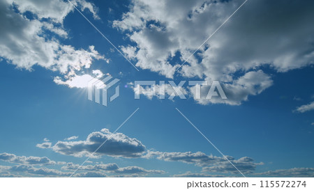 Solar energy concept of bright sun ray. Building clouds and sun rays breaking through cloud mass. Timelapse. 115572274