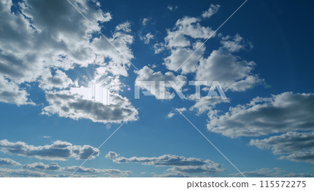 Beautiful blue sky cloudy behind shining sun rays and eventually breaking through cloud mass. Timelapse. Beautiful blue sky cloudy behind shining sun rays and eventually breaking through cloud mass. Timelapse. 115572275
