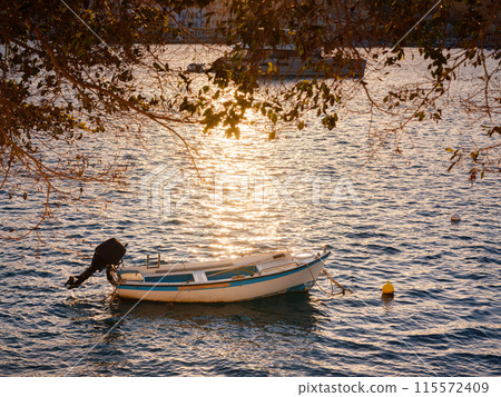 View on Symi or Simi island harbor port, small fishing boats in bay, houses on island hills, Aegean Sea bay. Greece islands holidays vacation travel tours from Rhodos island. View on Symi or Simi island harbor port, small fishing boats in bay, houses on island hills, Aegean Sea bay. Greece islands holidays vacation travel tours from Rhodos island. 115572409