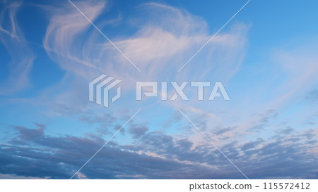 Intense dramatic panoramic sunset. Abstract different shades clouds at sunset sky background. Timelapse. 115572412