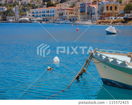 View on Symi or Simi island harbor port, classical ship yachts, houses on island hills, Aegean Sea bay. Greece islands holidays vacation travel tours from Rhodos island. Symi, Greece, Dodecanese. View on Symi or Simi island harbor port, classical ship yachts, houses on island hills, Aegean Sea bay. Greece islands holidays vacation travel tours from Rhodos island. Symi, Greece, Dodecanese. 115572425