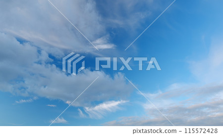 Cirrus clouds flying slowly on beautiful blue sky horizon background. Timelapse. 115572428