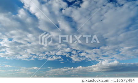 Tropical summer sunlight. White and blue cumulus and cirrocumulus on different layers clouds background. Tropical summer morning bright sunlight. Timelapse. Tropical summer sunlight. White and blue cumulus and cirrocumulus on different layers clouds background. Tropical summer morning bright sunlight. Timelapse. 115572494