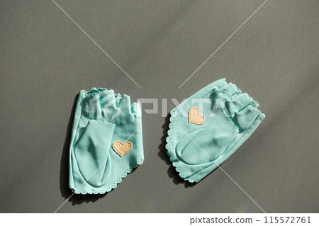 A pair of blue leather mittens with a white heart A pair of blue leather mittens with a white heart 115572761