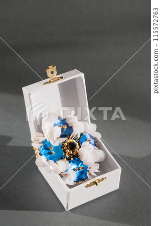 Handmade brooch with mother-of-pearl blue buttons and white sequins in a small box Handmade brooch with mother-of-pearl blue buttons and white sequins in a small box 115572763