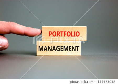 Portfolio management symbol. Concept words Portfolio management on beautiful wooden block. Beautiful grey paper background. Businessman hand. Business Portfolio management concept. Copy space. Portfolio management symbol. Concept words Portfolio management on beautiful wooden block. Beautiful grey paper background. Businessman hand. Business Portfolio management concept. Copy space. 115573038
