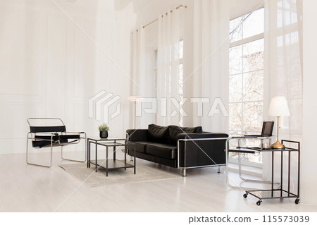 A bright room with large windows and modern furniture A bright room with large windows and modern furniture 115573039