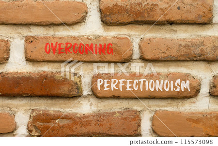 Overcoming perfectionism symbol. Concept words Overcoming perfectionism on beautiful brick wall. Beautiful red brown brick wall background. Business Overcoming perfectionism concept. Copy space. Overcoming perfectionism symbol. Concept words Overcoming perfectionism on beautiful brick wall. Beautiful red brown brick wall background. Business Overcoming perfectionism concept. Copy space. 115573098