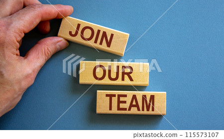 Wooden blocks form the words 'join our team' on blue background. Male hand. Business concept. Copy space. 115573107