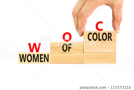 WOC women of color symbol. Concept words WOC women of color on beautiful wooden blocks. Beautiful white background. Businessman hand. Business WOC women of color social issues concept. Copy space. 115573118