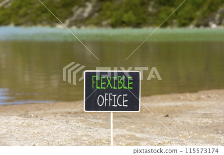 Flexible office symbol. Concept words Flexible office on beautiful yellow blackboard. Beautiful mountain lake sand beach background. Business Flexible office concept. Copy space. 115573174