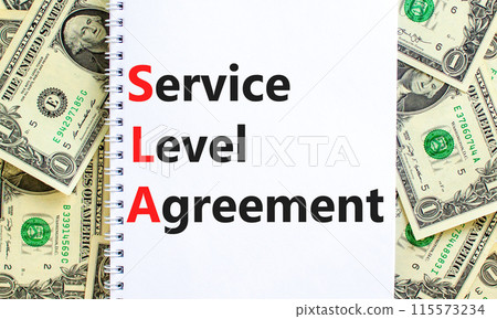 SLA service level agreement symbol. Concept words SLA service level agreement on beautiful white note. Beautiful dollar bills background. Business SLA service level agreement concept. Copy space. SLA service level agreement symbol. Concept words SLA service level agreement on beautiful white note. Beautiful dollar bills background. Business SLA service level agreement concept. Copy space. 115573234