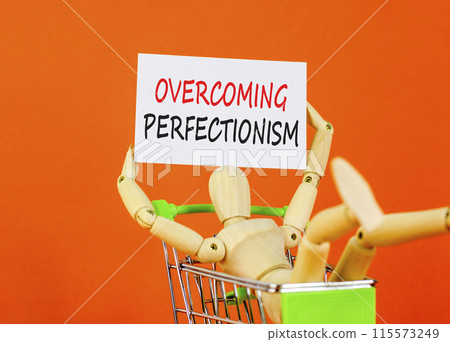 Overcoming perfectionism symbol. Concept words Overcoming perfectionism on white paper. Beautiful orange background. Businessman model, pushcart. Business Overcoming perfectionism concept. Copy space. Overcoming perfectionism symbol. Concept words Overcoming perfectionism on white paper. Beautiful orange background. Businessman model, pushcart. Business Overcoming perfectionism concept. Copy space. 115573249