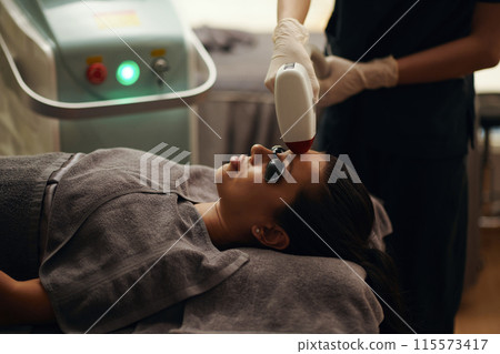 Cosmetologist Removing Facial Hair Cosmetologist Removing Facial Hair 115573417