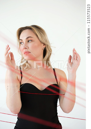 An adult woman with red threads. An adult woman with red threads. 115573523
