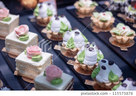 Desserts arranged on a table, displaying a variety of tasty treats 115573878