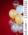 A bunch of light balloons on a red background. Vertical Photo Space for Text 115574382