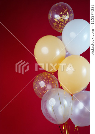 A bunch of light balloons on a red background. Vertical Photo Space for Text A bunch of light balloons on a red background. Vertical Photo Space for Text 115574382