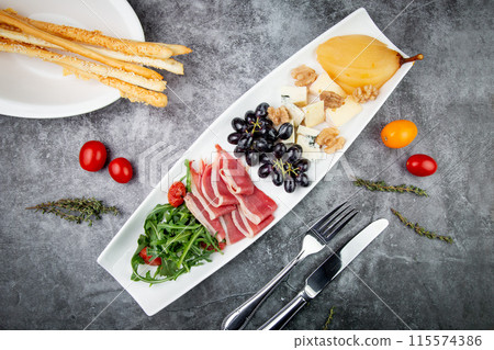 assorted fruits, grape nuts, bacon and arugula, top view 115574386