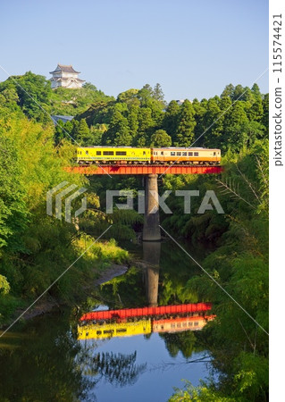 Otaki Castle and a local train running along a railway bridge, near Otaki Station on the Isumi Railway 115574421