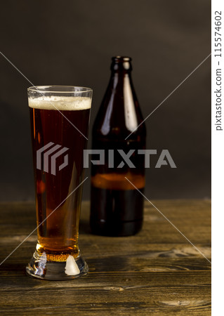 dark beer in a glass glass, fresh dark alcoholic beer 115574602
