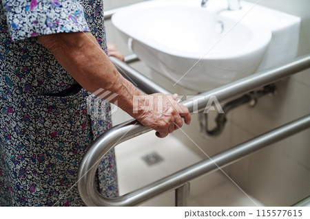 Asian elderly old woman patient use toilet support rail in bathroom, handrail safety grab bar, security in nursing hospital. Asian elderly old woman patient use toilet support rail in bathroom, handrail safety grab bar, security in nursing hospital. 115577615