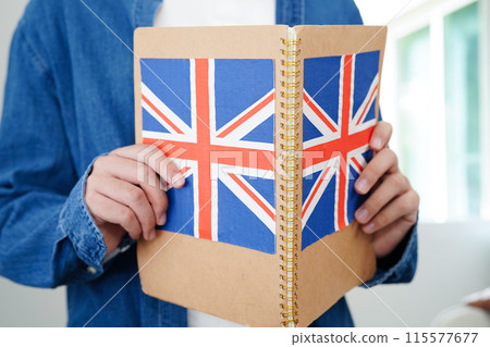 Learning English, Asian teenage student holding book with flag for language program education. Learning English, Asian teenage student holding book with flag for language program education. 115577677