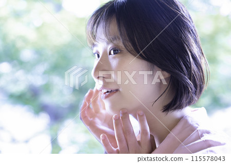 Female with fresh green and smiling Female with fresh green and smiling 115578043