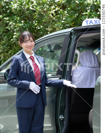 A female taxi driver welcoming customers with a smile 115580746
