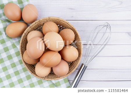 Organic chicken eggs and egg whisk Organic chicken eggs food ingredients. 115581464
