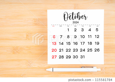 October 2024 calendar page and pen on wooden background. October 2024 calendar page and pen on wooden background. 115581784