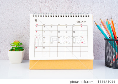 September 2024 Desk Calendar with wooden pencil on the table. 115581954