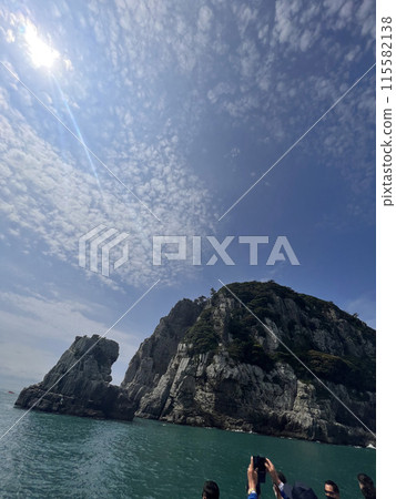 tourist taking a picture with a smartphone on the sea 115582138