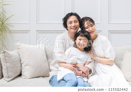 A young family relaxing in the living room A young family relaxing in the living room 115582442