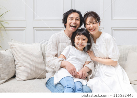 A young family relaxing in the living room A young family relaxing in the living room 115582443