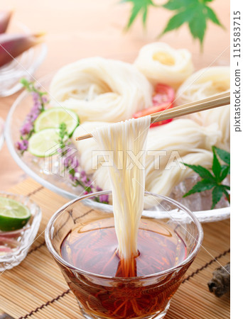 Eat chilled somen noodles by dipping them in sauce Eat chilled somen noodles by dipping them in sauce 115583715