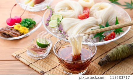 Eat chilled somen noodles by dipping them in sauce Eat chilled somen noodles by dipping them in sauce 115583717