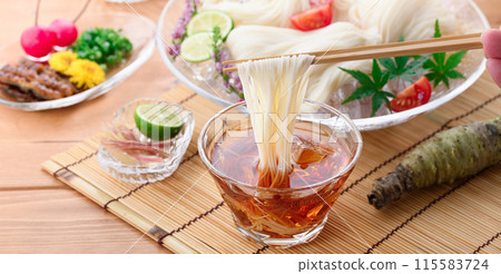 Eat chilled somen noodles by dipping them in sauce 115583724