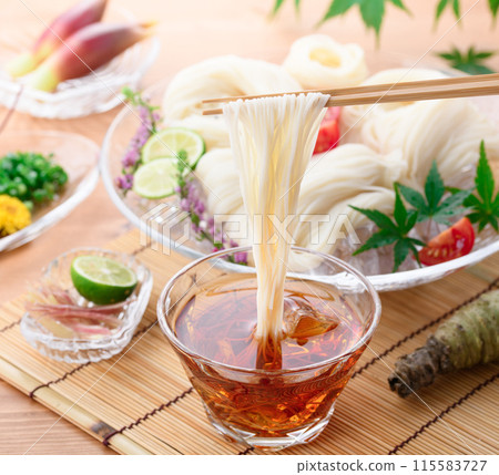 Eat chilled somen noodles by dipping them in sauce Eat chilled somen noodles by dipping them in sauce 115583727