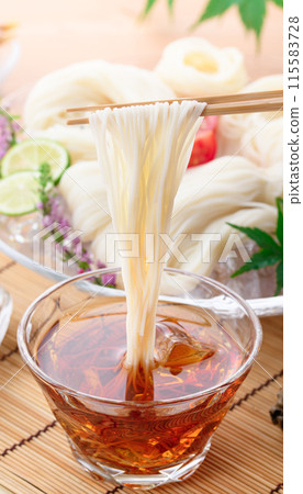 Eat chilled somen noodles by dipping them in sauce 115583728