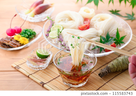 Eat chilled somen noodles by dipping them in sauce Eat chilled somen noodles by dipping them in sauce 115583743