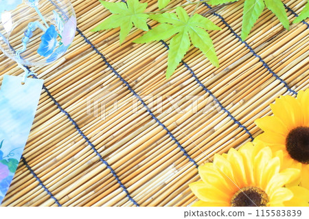 Wind chimes and artificial sunflowers on a bamboo blind Wind chimes and artificial sunflowers on a bamboo blind 115583839