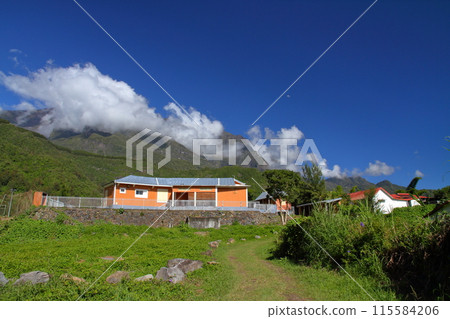 Buildings and mountain scenery of the village of Helbourg in the Cirque de Salazy, a World Heritage Site on the French overseas department of Reunion Island 115584206