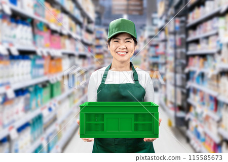 Asian seller wear green apron and cap smiling in retail store Asian seller wear green apron and cap smiling in retail store 115585673