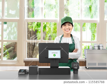 Active asian seller wear green uniform smiling with point of sale terminal or cashier desk 115585788