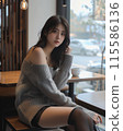 A woman relaxing at a cafe 115586136