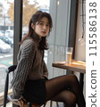 A woman relaxing at a cafe 115586138